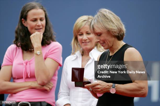 Martina Navratilova looks at a ring presented to her during her retirement ceremony at Arthur Ashe Stadium in Flushing Meadows-Corona Park as fellow...
