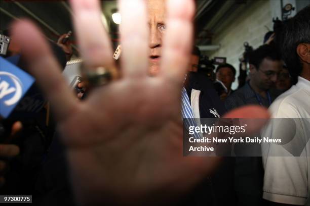 New York Yankees' owner George Steinbrenner decides he's camera shy as he holds up his hand to block the photographer's lens while making an...