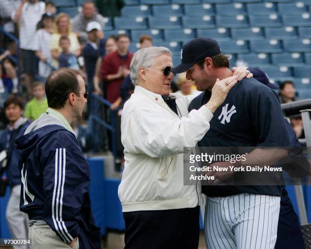 New York Yankees' owner George Steinbrenner embraces infielder Jason Giambi as general manager Brian Cashman looks on during a full squad workout at...