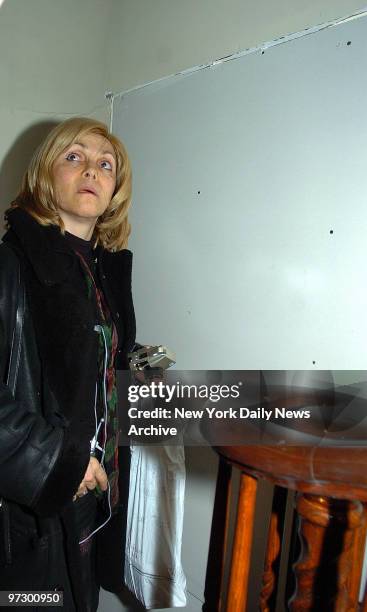 Chana Taub next to wall built today by her husband Simon Taub, who built a wall dividing their house in two,.