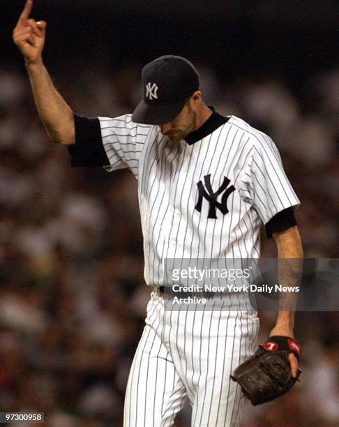 New York Yankees pitcher Jack McDowell gives the finger to the crowd after being removed from game against Chicago White Sox.