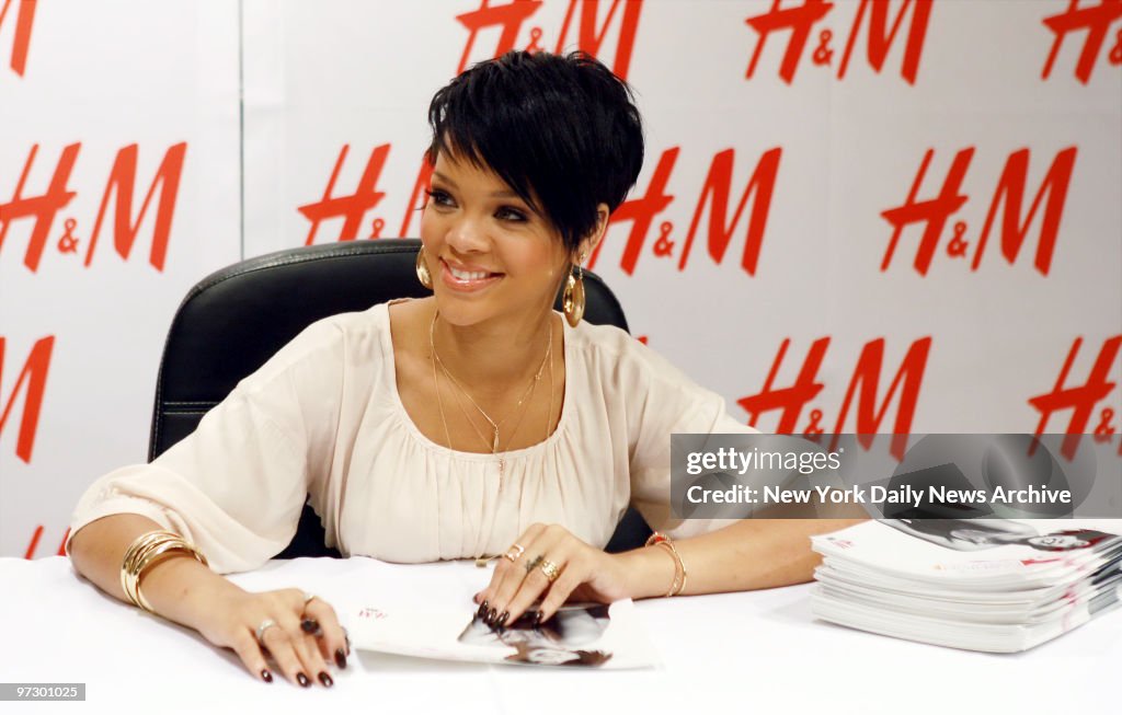Singer Rihanna signs autographs for fans at the H&M store on