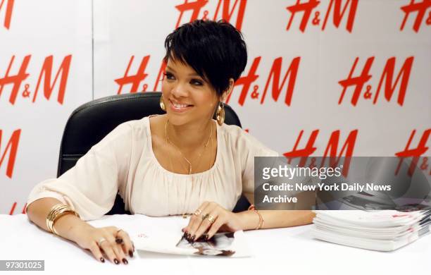 Singer Rihanna signs autographs for fans at the H&M store on Fifth Ave., where she made an appearance to promote a t-shirt she designed for the...