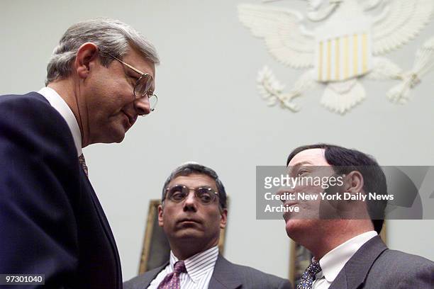 Thomas Renyi , chairman of the Bank of New York, talks with Rep. Michael Forbes during a break in the hearing of the House Banking Committee on the...