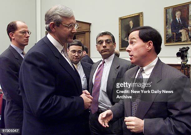 Thomas Renyi , chairman of the Bank of New York, talks with Rep. Michael Forbes during a break in the hearing of the House Banking Committee on the...