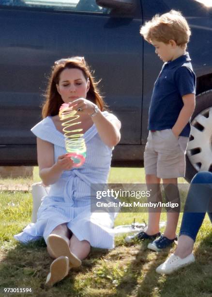 Prince George of Cambridge looks on as Catherine, Duchess of Cambridge plays with a Slinky toy at the Maserati Royal Charity Polo Trophy at the...