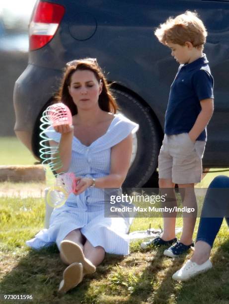 Prince George of Cambridge looks on as Catherine, Duchess of Cambridge plays with a Slinky toy at the Maserati Royal Charity Polo Trophy at the...