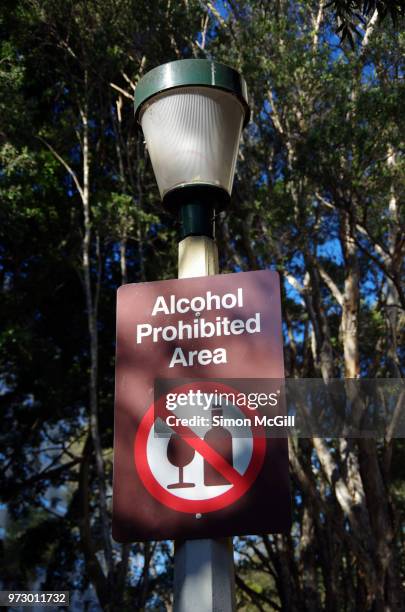 'alcohol prohibited area' sign on a street light in a public park - no drinking stock pictures, royalty-free photos & images