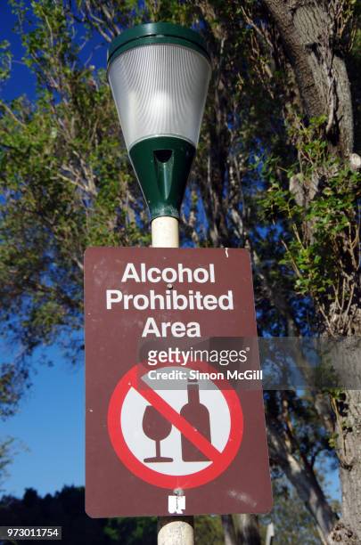 'alcohol prohibited area' sign on a street light in a public park - no drinking stock pictures, royalty-free photos & images