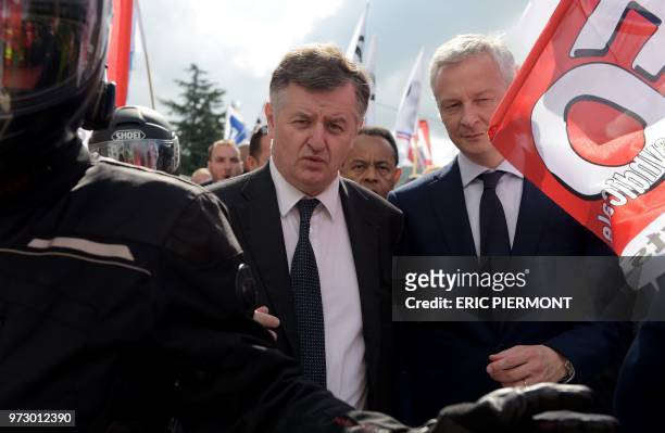 Augustin de Romanet , head of the ADP group and French Economy Minister Bruno Le Maire walk towards the ADP headquarters as protesters gather near...