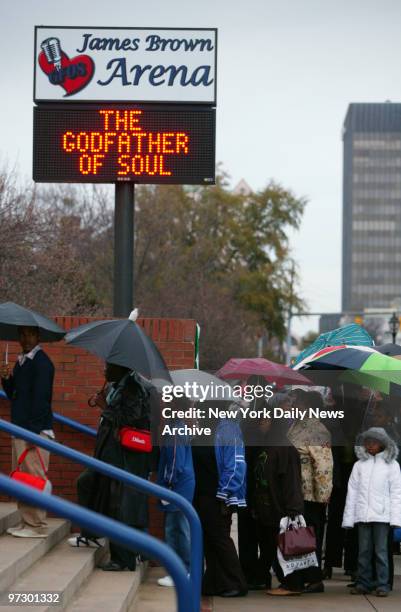 Thousands of mourners brave the rain to bid farewell to hometown legend James Brown, who was known as the "Godfather of Soul," during a public...