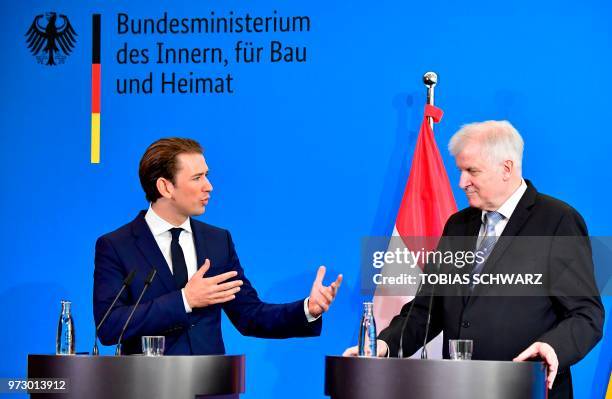 Austrian Chancellor Sebastian Kurz gestures next to German Interior Minister Horst Seehofer during a press conference at the Interior Ministry in...