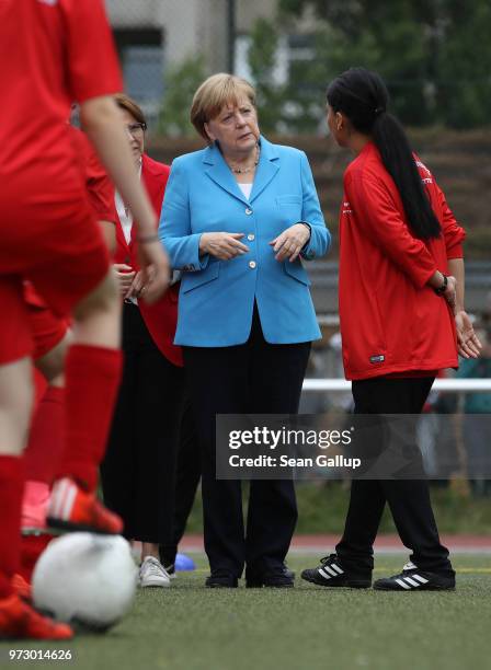 German Chancellor Angela Merkel visits a program to encourage integration of children with foreign roots through football at the SV Rot-Weiss...