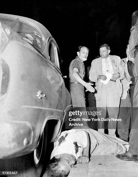 Charles LaCascia stands over the body of his brother-in-law, Cristiforo Robins, after gunmen killed him outside the People's Regular Democratic Club...