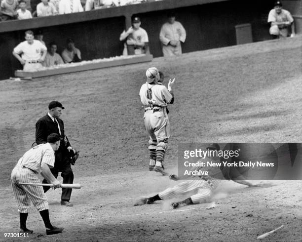 Joe Dimaggio slides in with a fifth-inning run during a 9-0 victory over the Browns at Yankee Stadium. This was game 12 of 1 16-game hitting streak...
