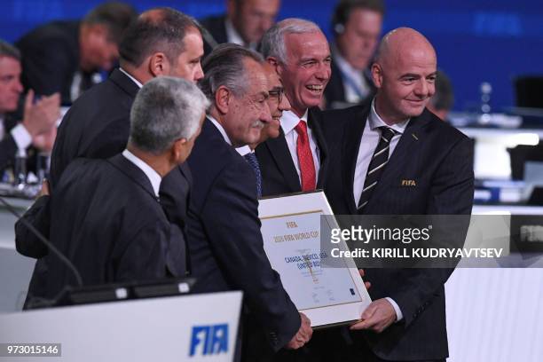 President Gianni Infantino poses with the United 2026 bid officials Carlos Cordeiro , president of the United States Football Association, president...