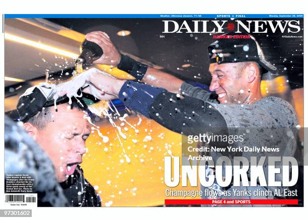 Front page of the Daily News for September 28 headline: Uncorked, Champagne flows as Yanks clinch AL East, photo of Derek Jeter giving Alex Rodriguez...
