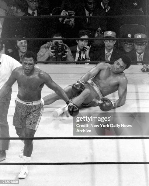 Joe Frazier confidently heads for neutral corner after knocking out Muhammad Ali in the 15th round at Madison Square Garden. The decesion was...