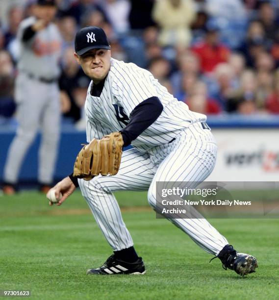 New York Yankees starting pitcher Mike Thurman picks up the ball to throw to first after a ball hit off of his right thigh during second inning...