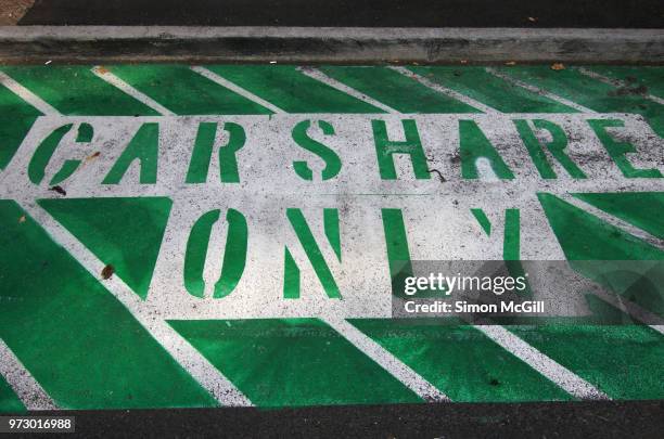 car share only parking space stencilled on a road - car sharing stock pictures, royalty-free photos & images