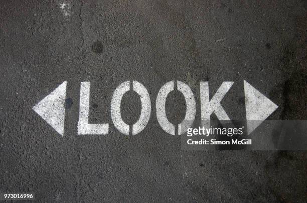 sign stencilled on a road to remind pedestrians to look in both directions before crossing - sydney from above stock pictures, royalty-free photos & images