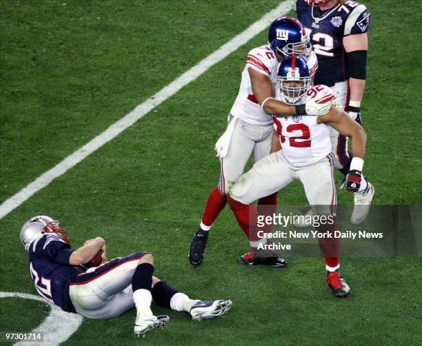 New York Giants' defensive end Michael Strahan celebrates after sacking New England Patriots' quarterback Tom Brady in the third quarter of Super...
