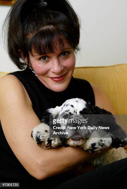 Singer Sylvia McNair hugs her 1-year-old cocker spaniel at the Algonquin Hotel on W. 44th St. The former opera star underwent a conversion on the...