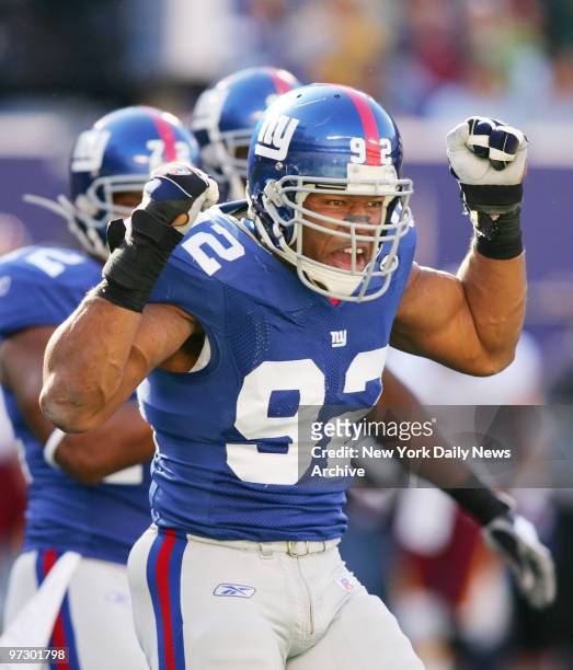 New York Giants' defensive end Michael Strahan celebrates getting a sack in the first quarter against the Washington Redskins at Giants Stadium. The...