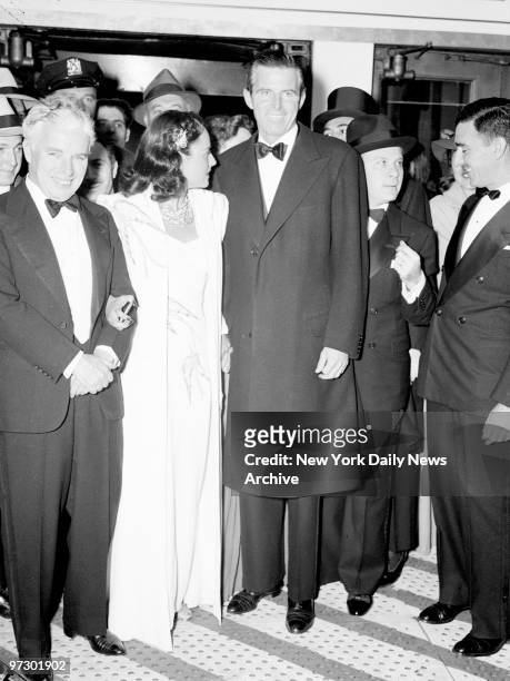 Charlie Chaplin with his wife Paulette Goddard and Tim Durante attending premiere of "The Great Dictator."