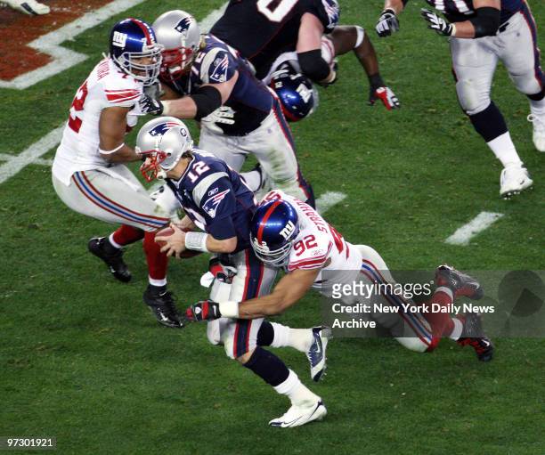 New York Giants' defensive end Michael Strahan sacks New England Patriots' quarterback Tom Brady in the third quarter of Super Bowl XLII at the...