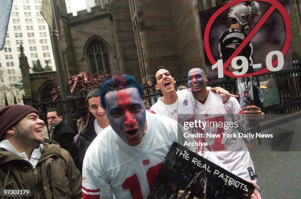 New York Giants fans stand outside Trinity Church for the victory parade along lower Broadway, for the Super Bowl XLII champion New York Giants.