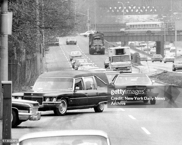 Funeral cortege of Frank Costello hardly disturbs traffic as hearse turns into St. Michael's Cemetery, Astoria, Queens. Costello who died Sunday at...
