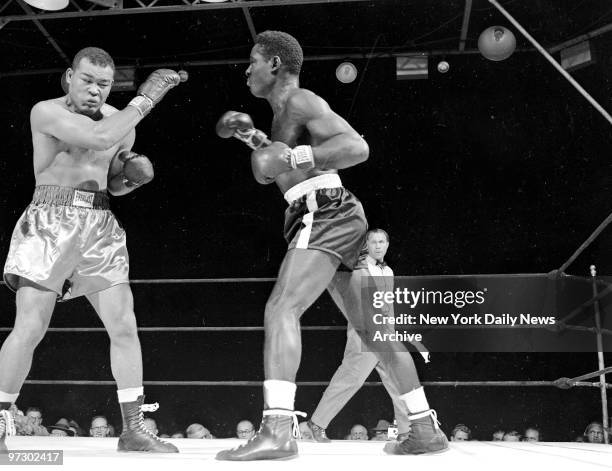 Joe Louis and Ezzard Charles in action during bout at Yankee Stadium. Charles defeated Louis in 15 rounds to capture the vacant World Heavyweight...