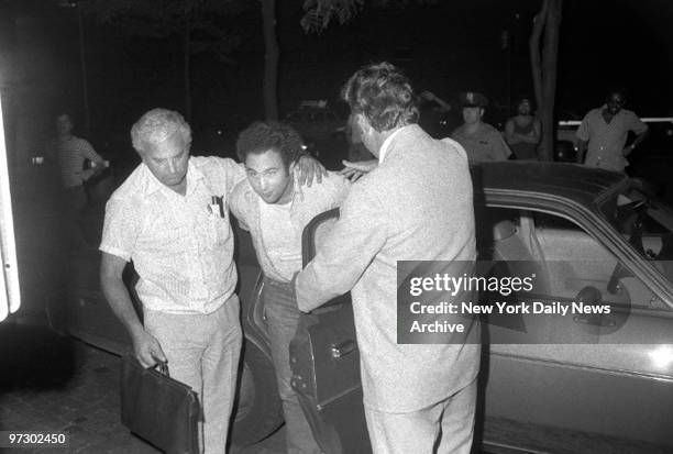 David "Son of Sam" Berkowitz is apprehended and brought to police headquarters at 1 Police Plaza.