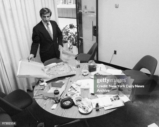 Chase Manhattan Bank robbery holdup. Chase Vice President Michael J. Calandra looks over mess-including an untouched pizza. Big-tipping robbers...