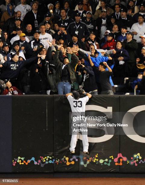 Chase Utley's drive proves out of reach for New York Yankees' Nick Swisher as fans in right field try to catch third inning home run at Yankee...