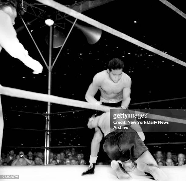 Joe Louis versus Max Schmeling II., Knockdown No. 1! Max plunges to the canvas, propelled by the battering-ram socks of the Tan Tornado.
