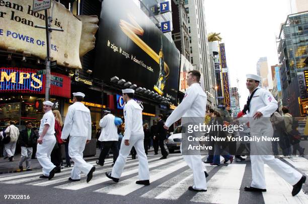 Cheerful sailors cross W. 42nd St. At Seventh Ave. As they explore Times Square during Fleet Week.