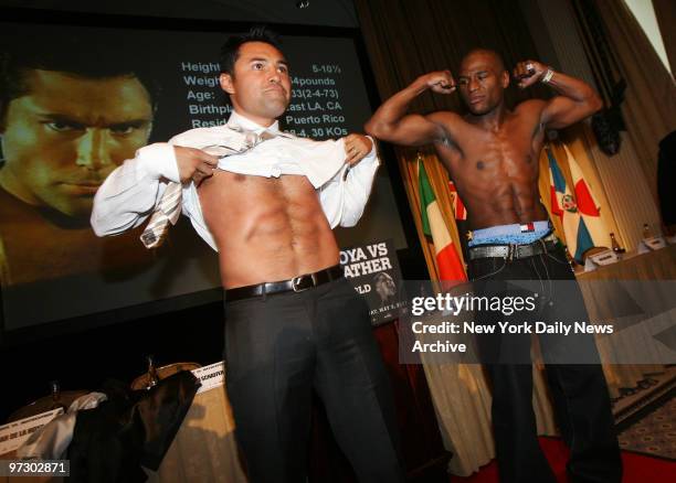 Defending junior middleweight champion Oscar De La Hoya and Floyd Mayweather Jr. Show off their goods before a news conference at the Starlight Roof...