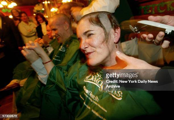 Mary Roddy grins and bares it as her locks are shorn at Jim Brady's Pub on Maiden Lane in lower Manhattan. Roddy was taking part in the annual St....