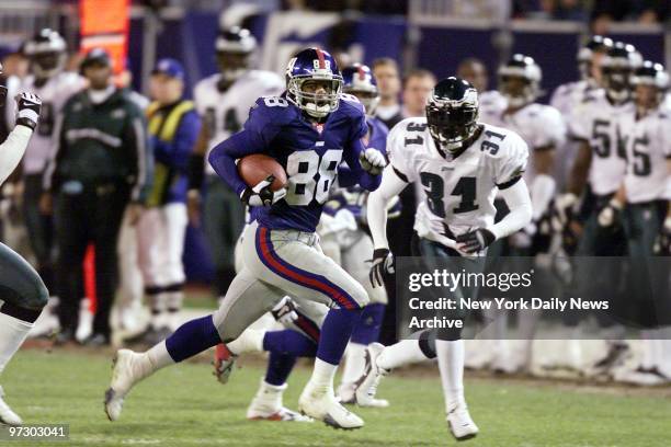 New York Giants' Ike Hilliard gains some yardage during second quarter game action against the Philadelphia Eagles at Giants Stadium. Although...