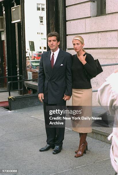 John F. Kennedy Jr. And bride Carolyn Bessette Kennedy stand in front of their apartment in Tribecca.