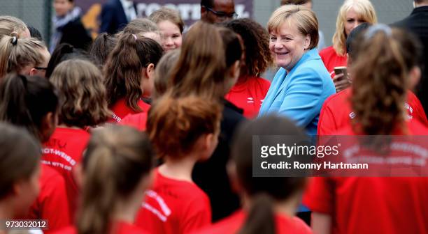 German Chancellor Angela Merkel smiles during her visit at a program to encourage integration of children with foreign roots through football at the...