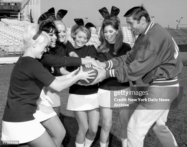 Joe Namath, who completes most of his passes, goes onto the defense at Shea Stadium as he meets members of the Playboy Bunny touch football team, of...