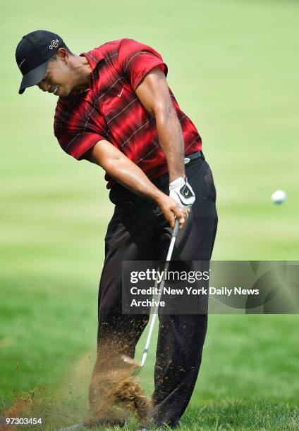 Tiger Woods of the U.S. Hits from the rough on the first hole during the fourth round of play in the 87th PGA Championship at Baltusrol Golf Club in...