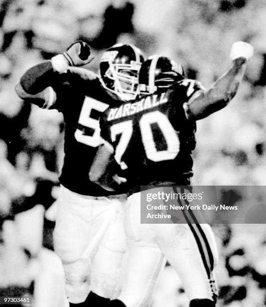 New York Giants Leonard Marshall and Pepper Johnson celebrate the sack of Buffalo's Jim Kelly in the second quarter during Superbowl XXV.