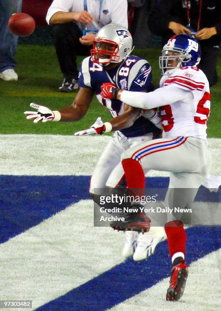 New York Giants' linebacker Antonio Pierce interferes with New England Patriots' tight end Benjamin Watson in the end zone during the first quarter...
