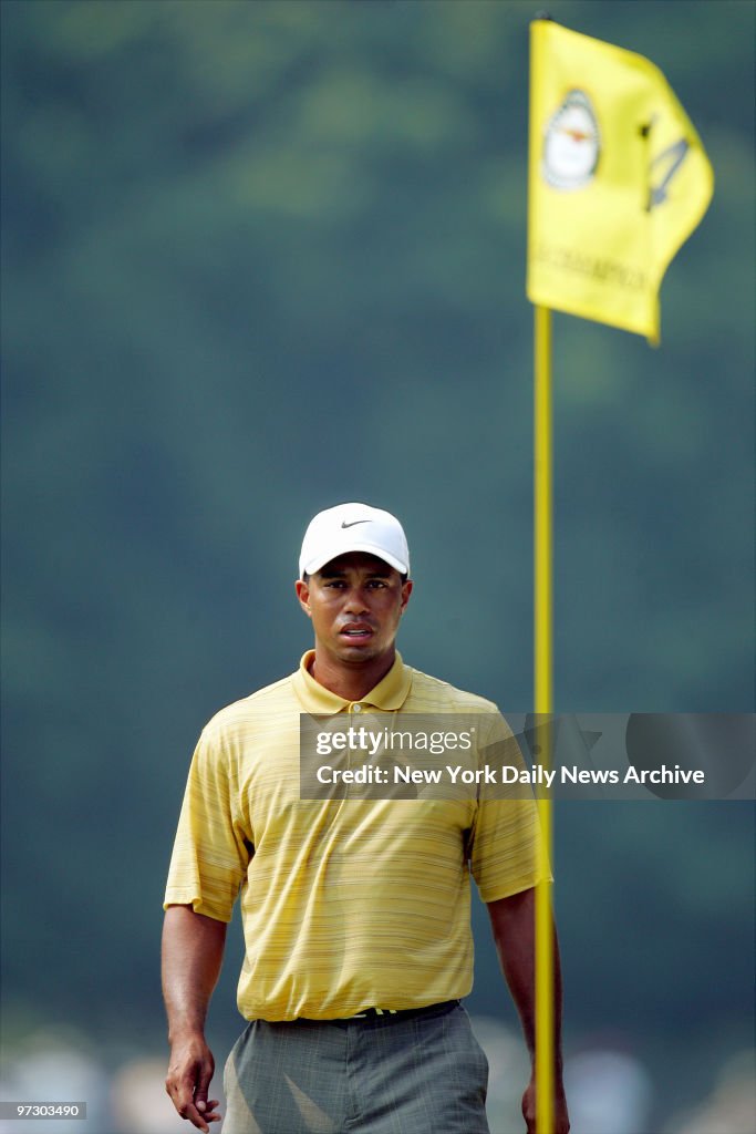 Tiger Woods of the U.S. walks up to the 14th green during hi
