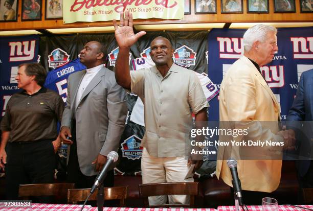 New York Giants' linebacker Harry Carson waves to the media during a news conference at Gallagher's Steakhouse in Manhattan, where former teammates...