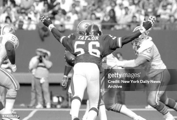 New York Giants' linebacker Lawrence Taylor looks ready to devour Detroit Lions' quarterback Rusty Hilger. The young Lion completed only 9 of 28...